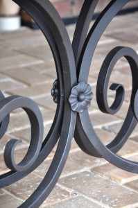 close up of wrought iron table base showing flower detail