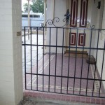Wrought iron gate for side entrance of house